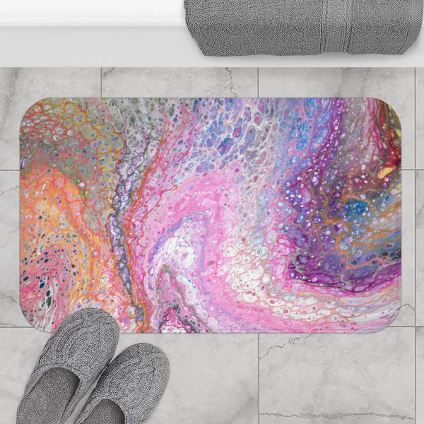 Pink galaxy abstract art bath mat on gray bathroom floor