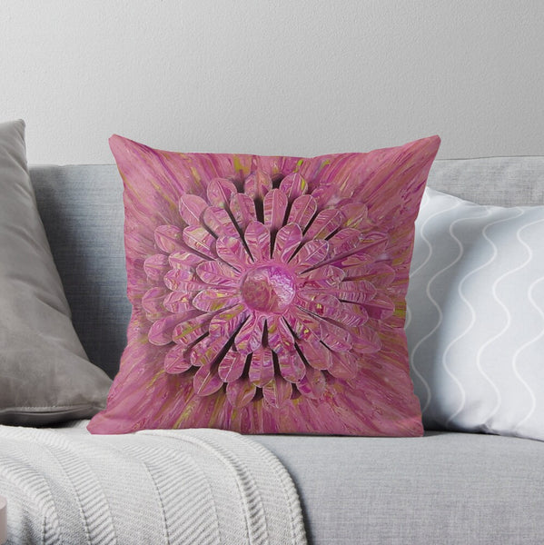 Pink flower pillow on gray couch