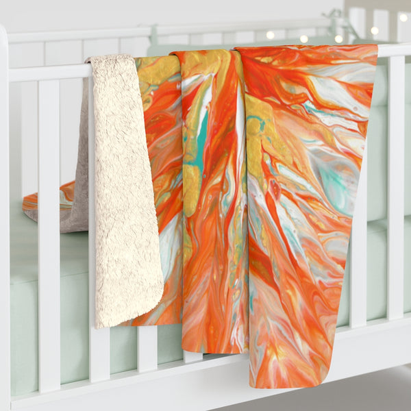 Orange and gold sherpa fleece blanket on baby crib
