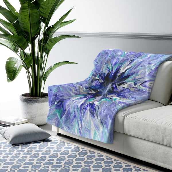 Lavender sherpa fleece blanket on couch