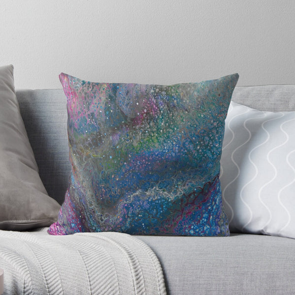 Blue galaxy pillow on gray couch
