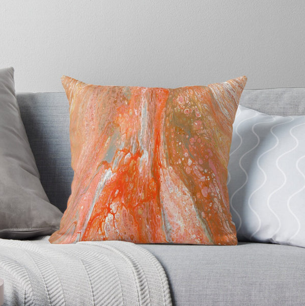 Orange abstract art pillow on gray couch