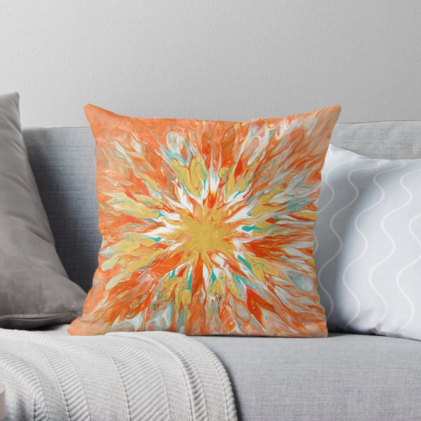 Orange and gold pillow on gray couch
