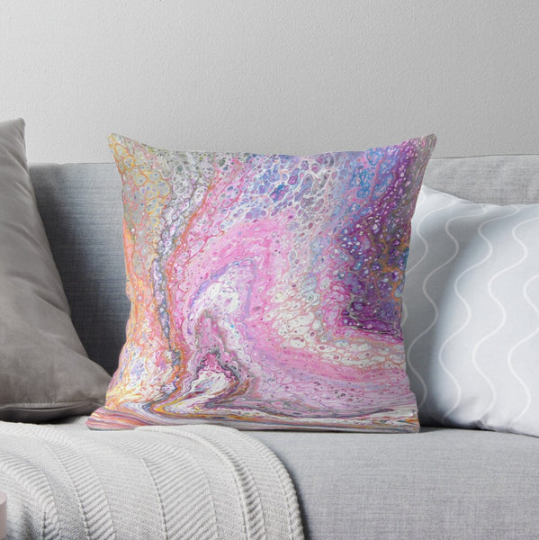 Pink galaxy abstract art pillow on gray couch