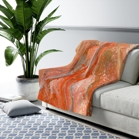 Orange abstract sherpa fleece blanket on couch