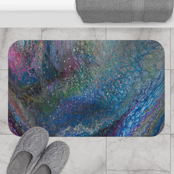 Blue galaxy bath mat on gray bathroom floor